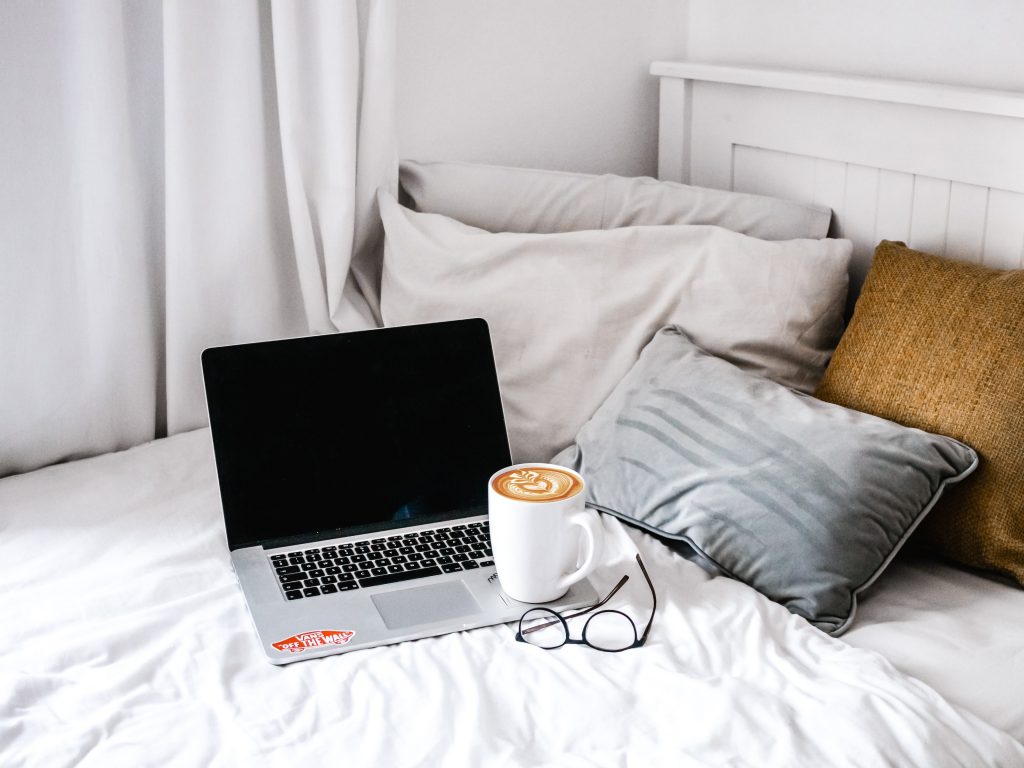 laptop and coffee on bed for blog post